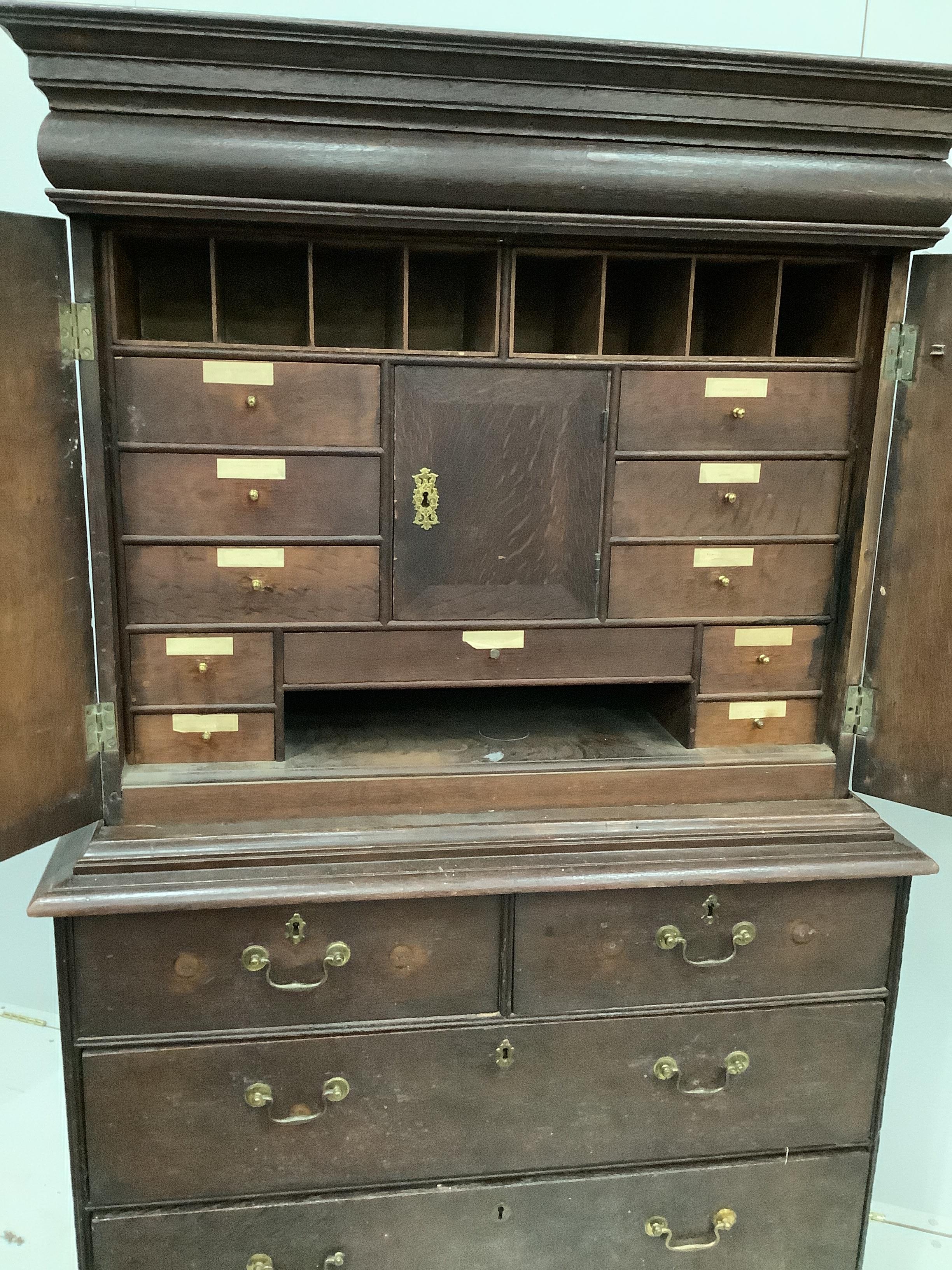 An 18th century oak cabinet on chest, width 107cm, depth 52cm, height 178cm